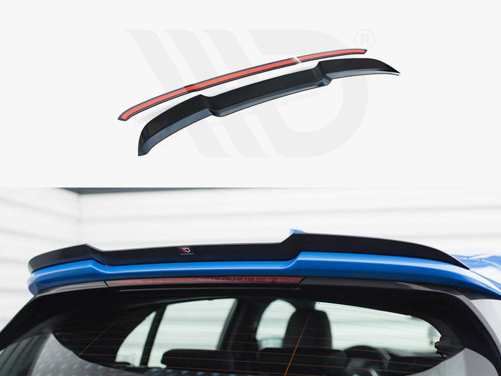 Rear vehicle spoiler, positioned on a blue car, enhances aerodynamics. The upper section shows the spoiler design with a red accent, highlighting its sleek shape. Indoor garage setting.