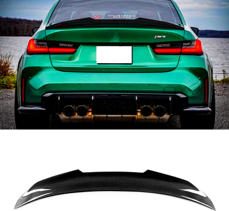 Green car with a visible "M3" badge parked beside a lake; quad exhausts below. Rear window displays “VALVETRONIC DESIGNS.” Below, a black carbon fiber spoiler appears on a white background.