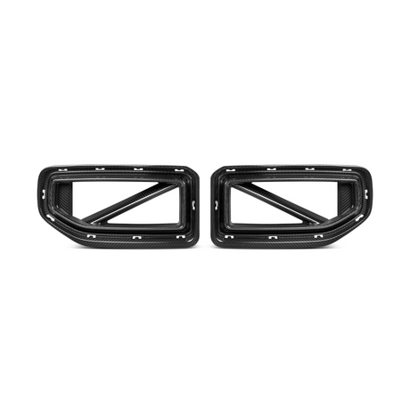 Two carbon fiber car exhaust trim pieces, designed with rectangular frames and diagonal supports, are positioned side by side against a plain white background.