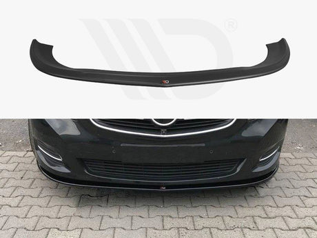 A black car front lip spoiler is shown both separately and installed on a dark-colored car, enhancing its aerodynamics. The car is parked on a stone-paved area.