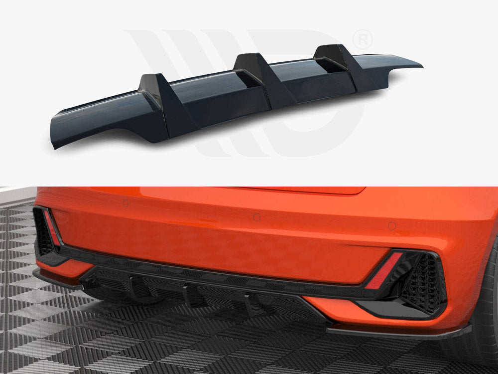 A black car rear diffuser shown separately and installed on an orange car's lower back bumper, displayed on a patterned garage floor, emphasizing aerodynamic style enhancements.