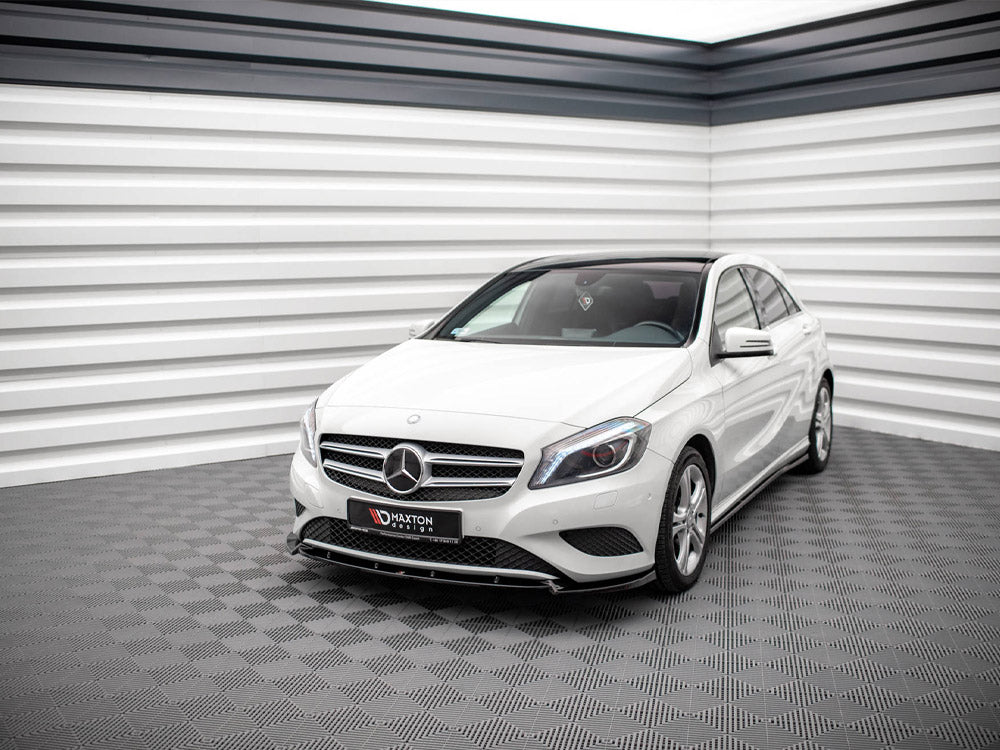 A white Mercedes-Benz car is parked in a modern, grey-tiled showroom with striped white and black walls. The front license plate reads "MAXTON design."