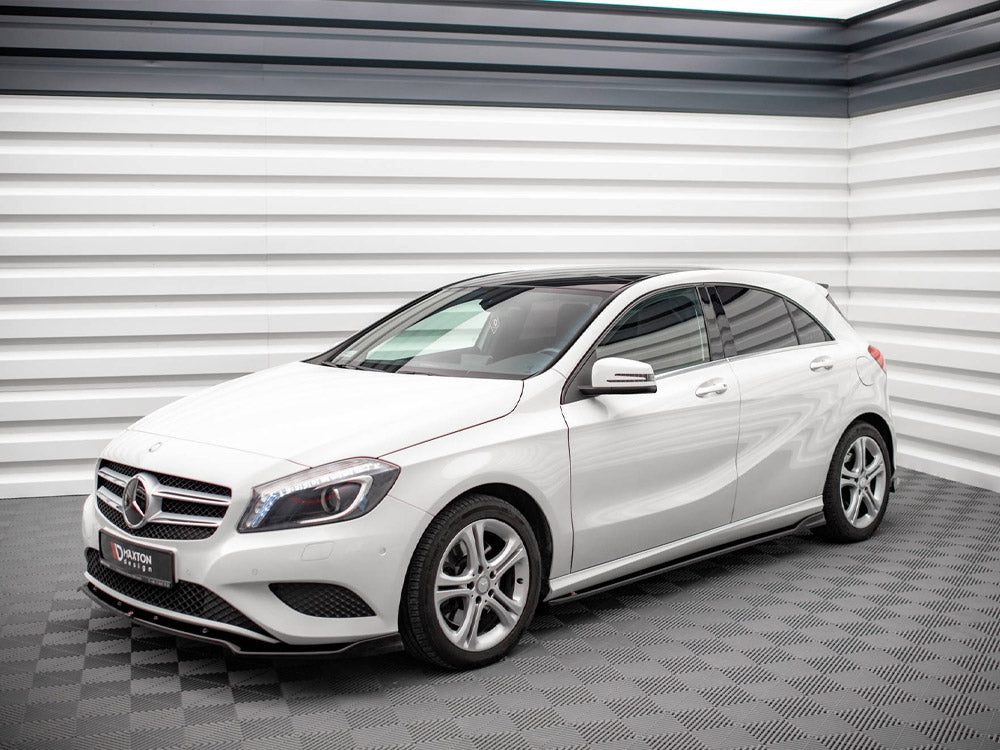 A white Mercedes-Benz hatchback is parked in a modern showroom with sleek, textured walls. A sign on the front reads "D'AXTON DESIGN."