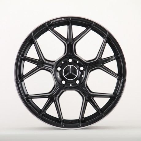 A black alloy wheel with a multi-spoke design, featuring the Mercedes-Benz logo at the center and "AMG" text, against a plain white background.