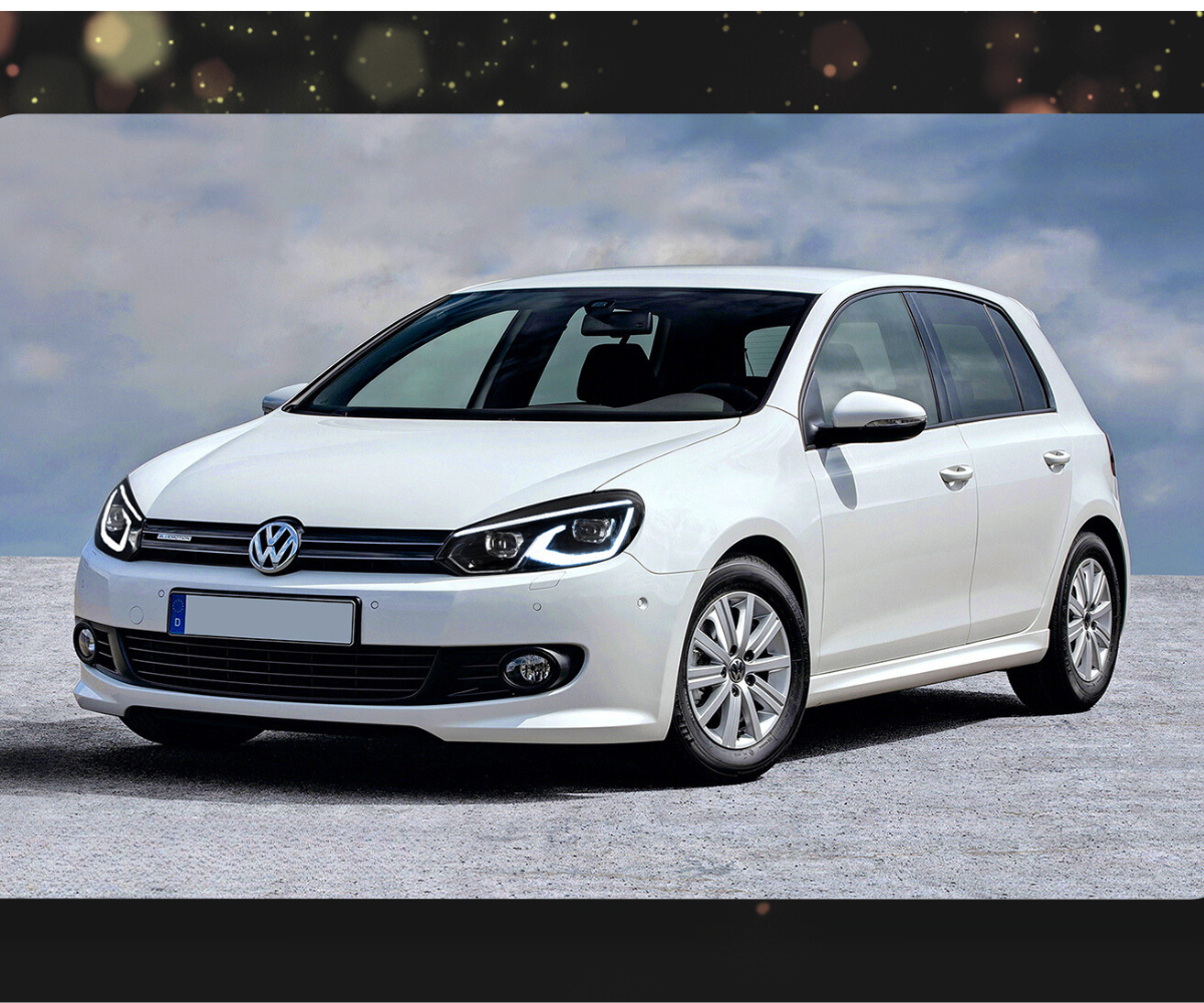 A white Volkswagen hatchback is parked on a rocky surface against a cloudy sky background.