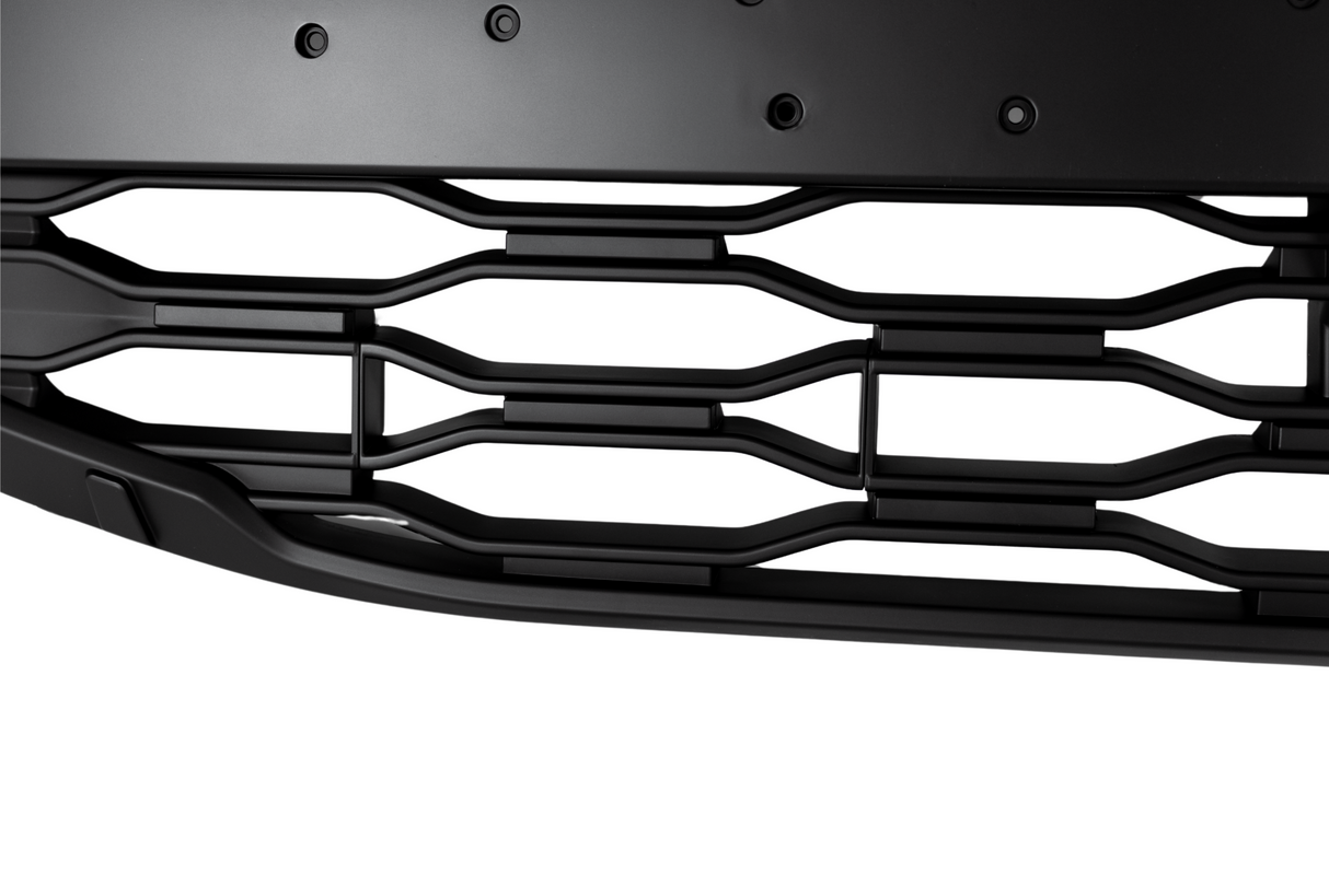 A black car grille featuring horizontal and vertical bars arranged in a wave pattern. The structure is part of a larger vehicle front, emphasizing sleek design elements in close-up.