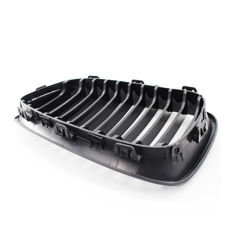 A black plastic car grille featuring horizontal slats and clips, designed for installation on a vehicle, displayed against a plain white background.