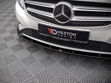 A car grille with a prominent emblem and "MAXTON design" plate is displayed. The vehicle is parked on a patterned, textured floor. Additional text: "Performance Center D&R Czach T: +48 17 860 12 20."