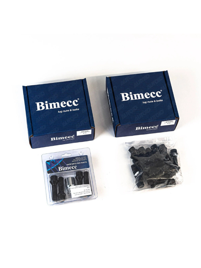 Boxes labeled "Bimecc lug nuts & bolts" are laid out. Next to them are a blister pack with lug nuts and a clear bag containing more nuts, all on a white surface.