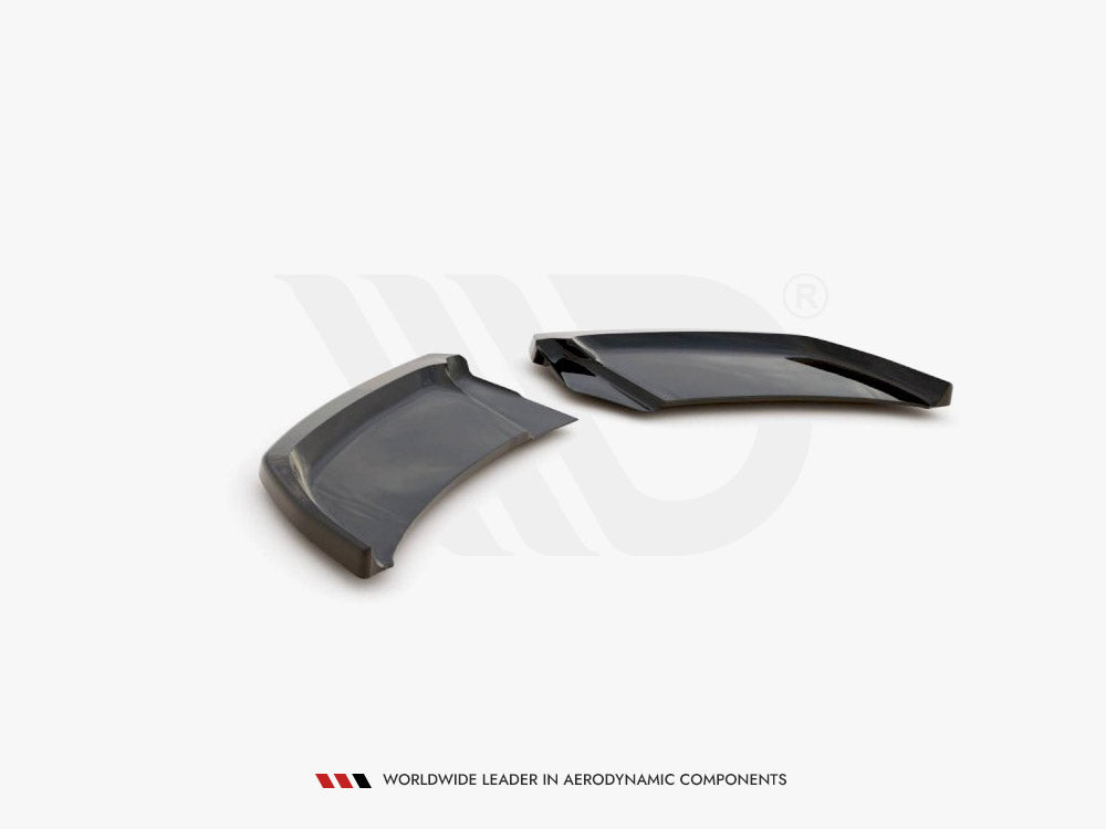 Two sleek, aerodynamic black plastic components rest on a white surface, angled adjacent to each other. Text below reads: "WORLDWIDE LEADER IN AERODYNAMIC COMPONENTS."