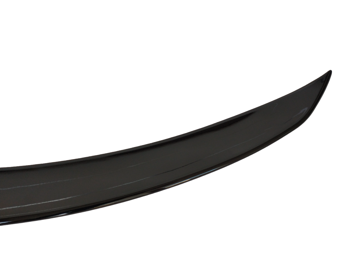 A shiny black car spoiler is displayed against a plain white background, showing its curved aerodynamic shape and glossy surface.