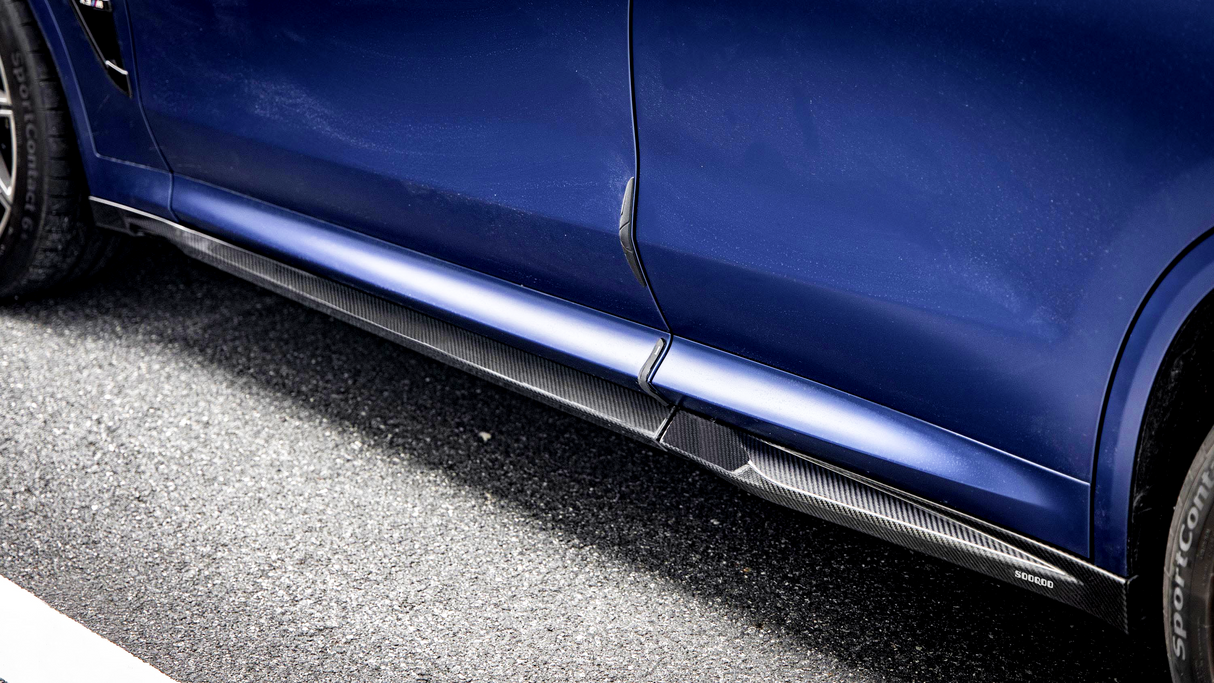 A blue car with side skirts and a visible tire on an asphalt road. The text "SPORTCONTACT" and "SODRUD" are marked on the components.