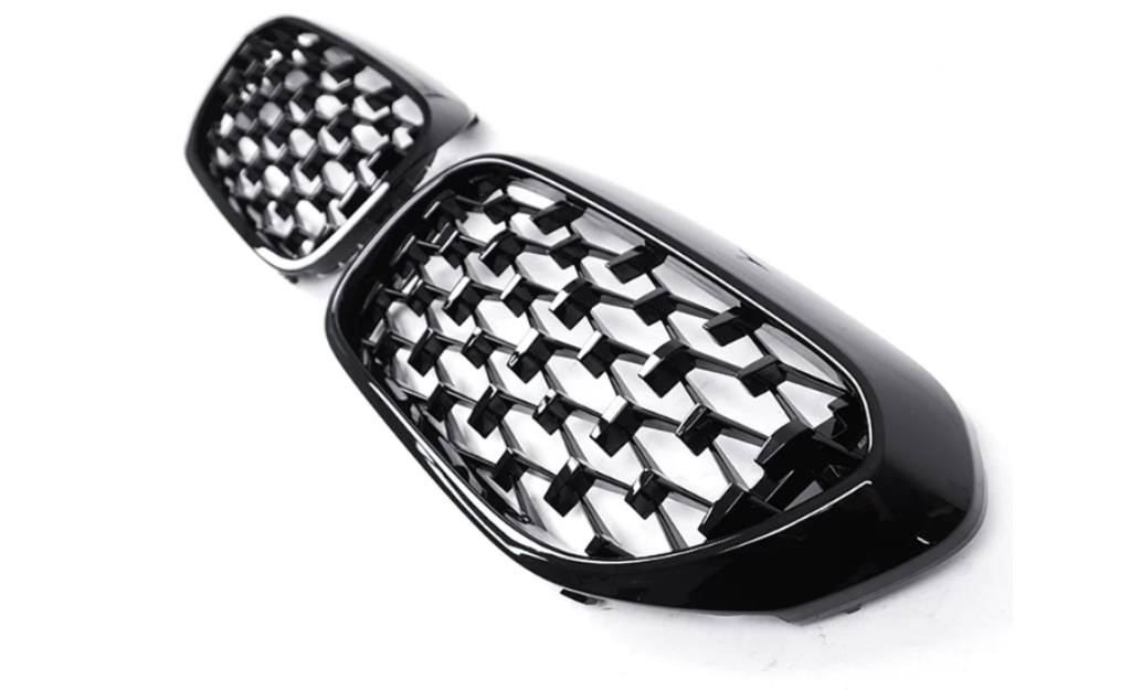 A pair of black, honeycomb-patterned car grille inserts are positioned on a plain white background, showcasing their glossy finish and intricate design.