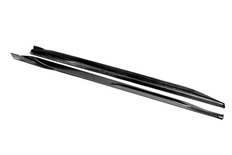 A pair of sleek black skis lies side by side, showcasing a glossy surface and streamlined design. The word "REDSTER" is visible on one ski, against a plain white background.