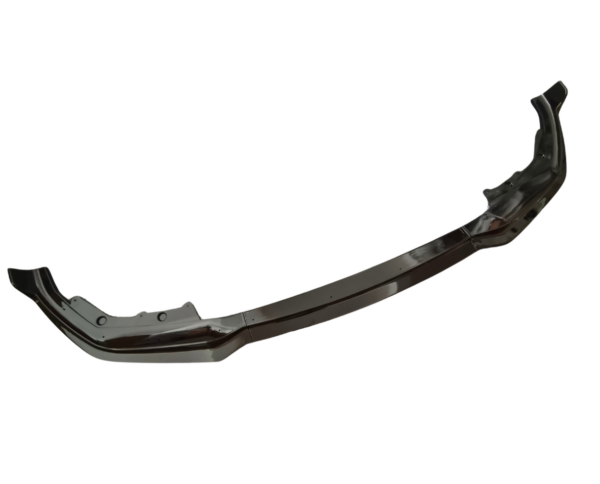 A dark, curved car bumper is shown from a front angle, displaying its aerodynamic design against a plain white background.