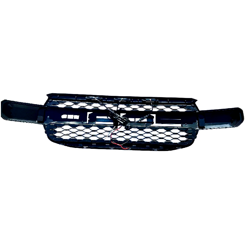 A black honeycomb car grille with integrated wiring lies on a white background. The grille has a structured design, suitable for vehicle front-end placement, providing ventilation and protection.