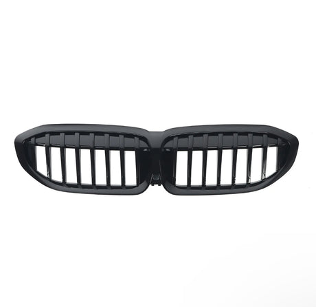A glossy black car grille with vertical slats, shaped in two connected oval sections, is isolated on a white background.