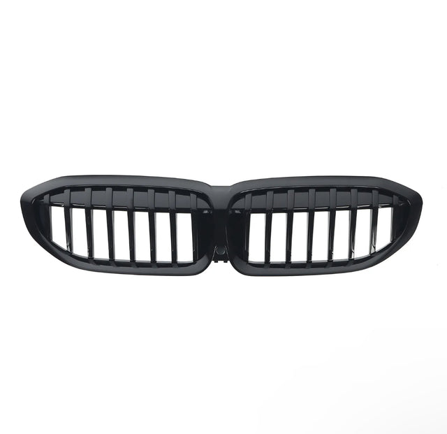 A glossy black car grille with vertical slats, shaped in two connected oval sections, is isolated on a white background.