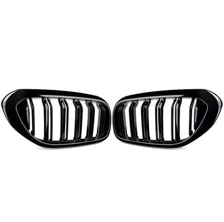 Two black car grille inserts with vertical slats are positioned symmetrically. They rest against a plain white background, showing a sleek, glossy finish.