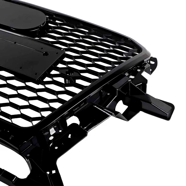 A black car grille with a honeycomb pattern and mounting brackets is positioned against a white background.