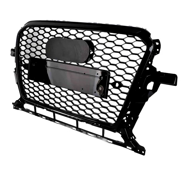 A black honeycomb car grille with a central rectangular attachment and rounded emblem sits against a plain white background.