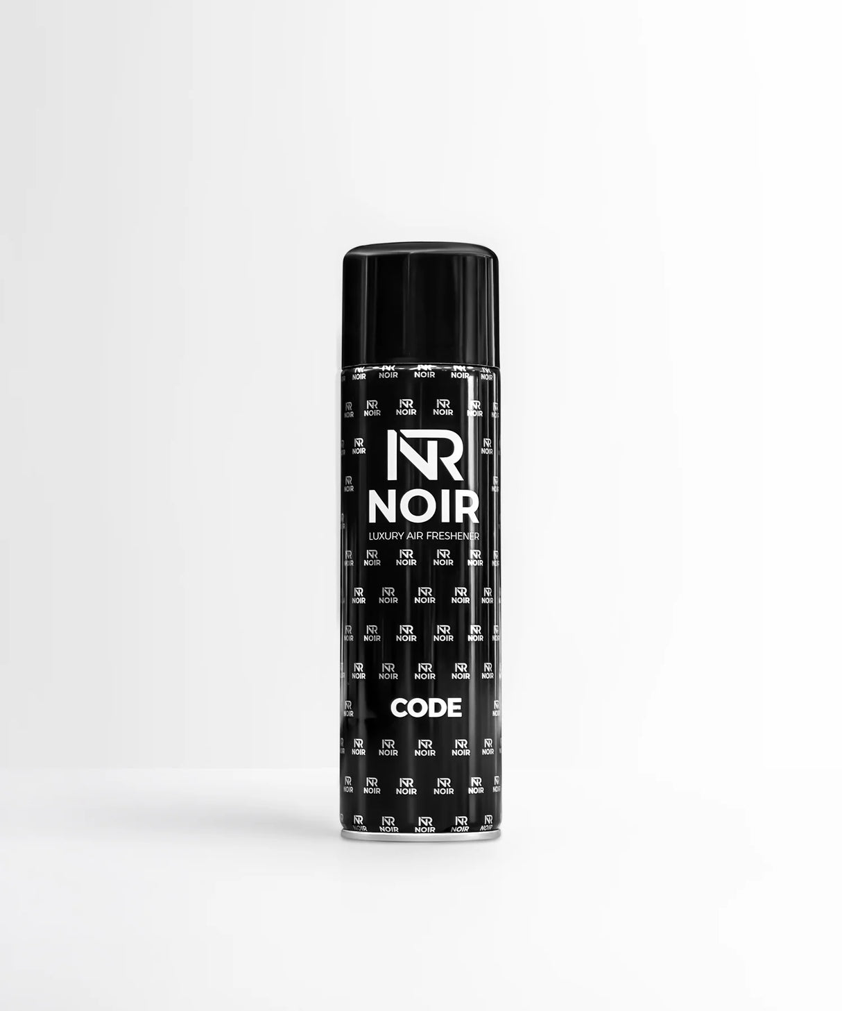 A black cylindrical can labeled "NR NOIR LUXURY AIR FRESHENER CODE" stands upright. It features a repeating logo pattern in a minimalist white room.