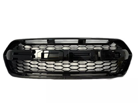 A black car grille featuring large, bold "FORD" lettering, designed with a honeycomb pattern, set against a plain white background.