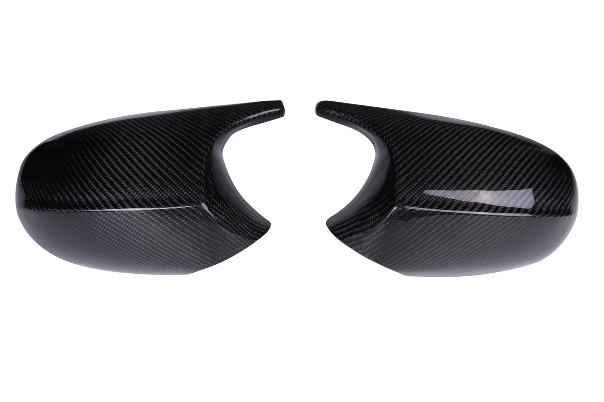 Two black carbon fiber car mirror covers are placed side by side on a plain white background, showcasing a glossy finish and a textured pattern.