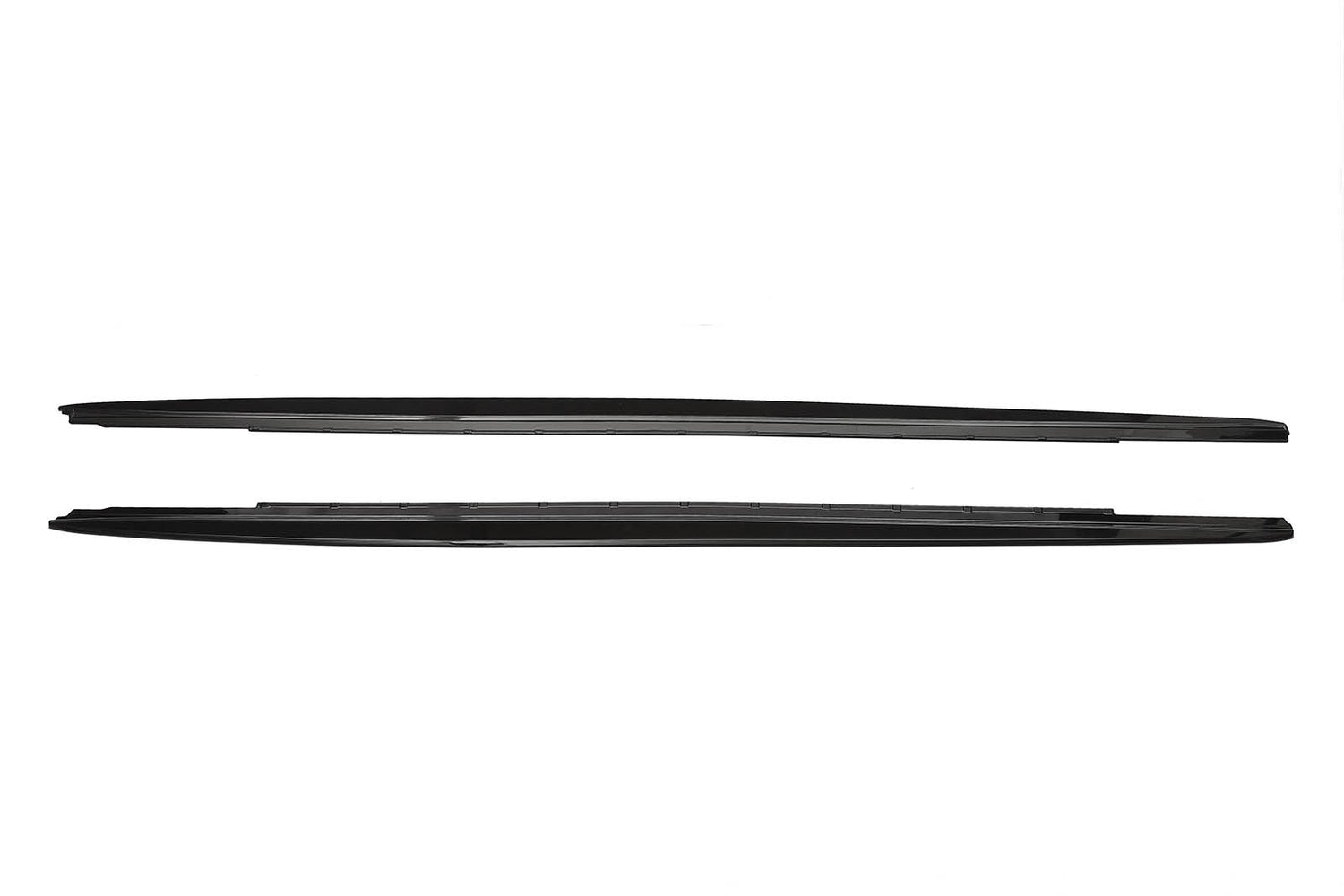 Two sleek, black car side skirts, aligned horizontally, lie against a plain white background, showing their aerodynamic design and smooth edges.