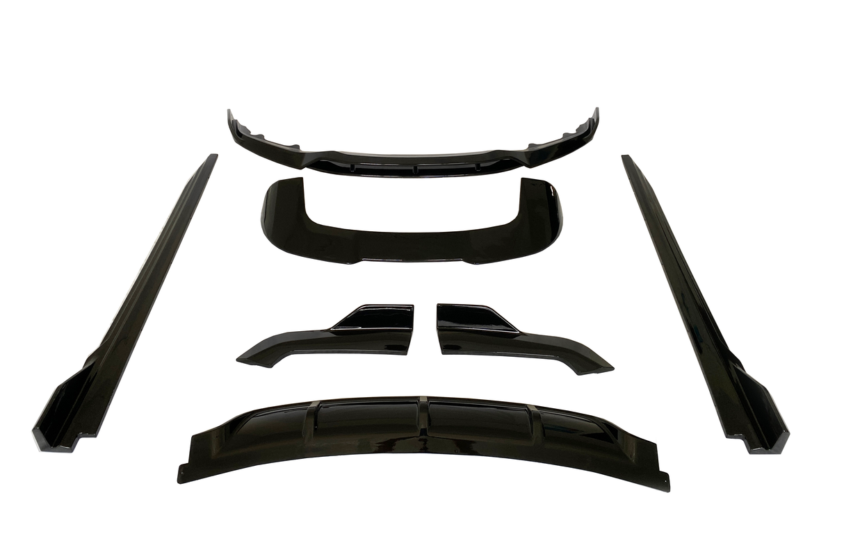 Black car body kit pieces arranged on a white background, including a bumper lip, side skirts, and diffuser parts, all presented symmetrically and evenly spaced.