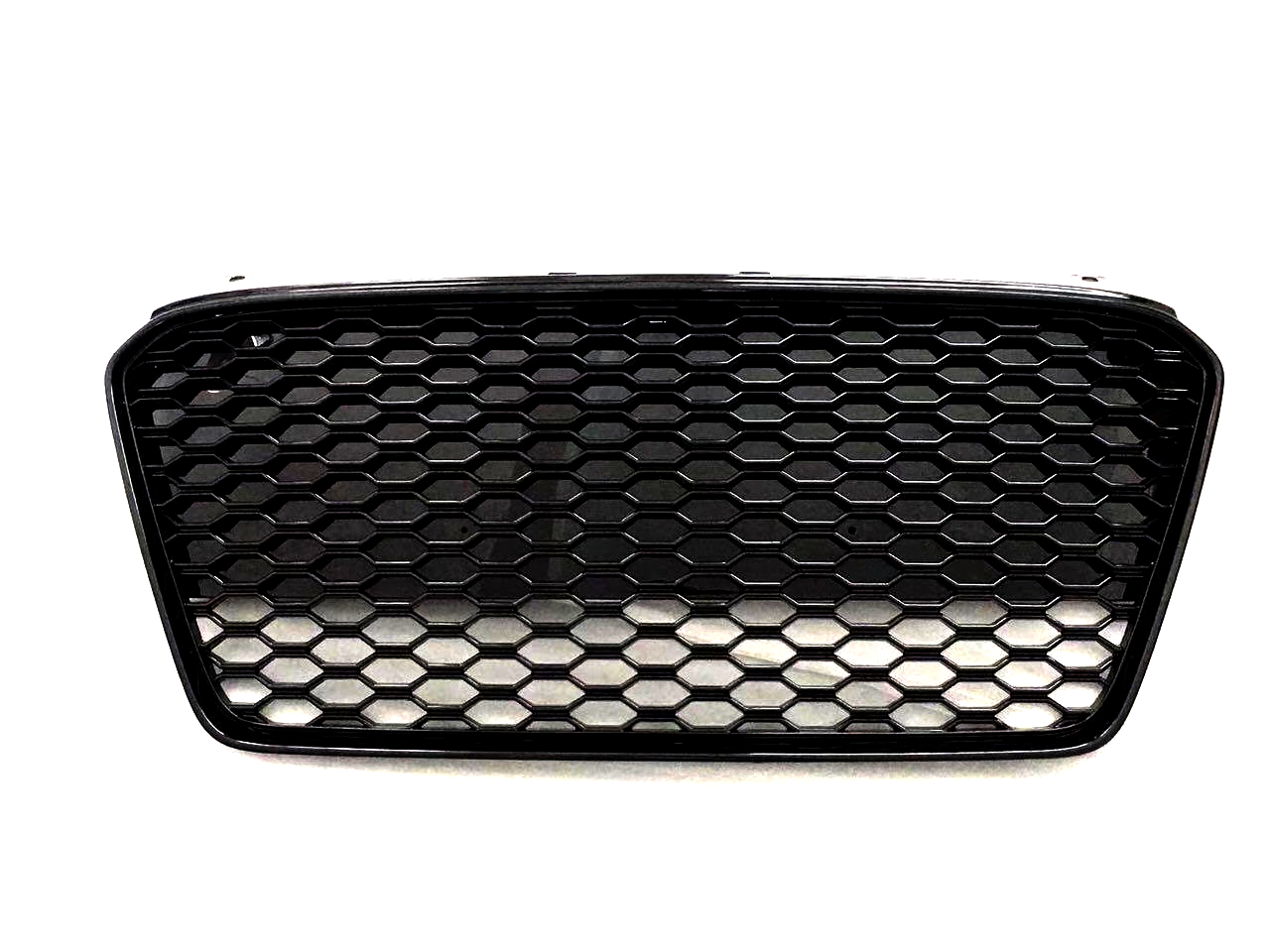 A black car grille with a honeycomb pattern appears against a plain white background, showcasing its sleek design and geometric texture.