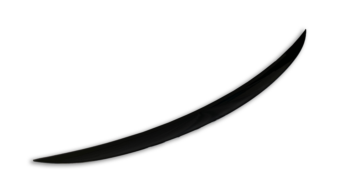 A single, black, curved object resembles a blade or tusk, positioned diagonally against a plain white background, suggesting a sleek and minimalist design.