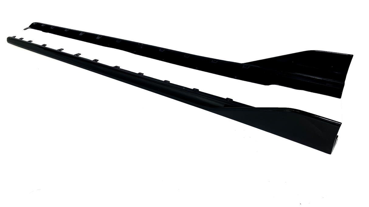 Two long, black car side skirts are positioned parallel on a white background, showcasing attachment points and a sleek, aerodynamic shape.