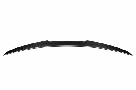 A black carbon fiber car spoiler, slightly curved, is suspended against a plain white background, showcasing its aerodynamic design.