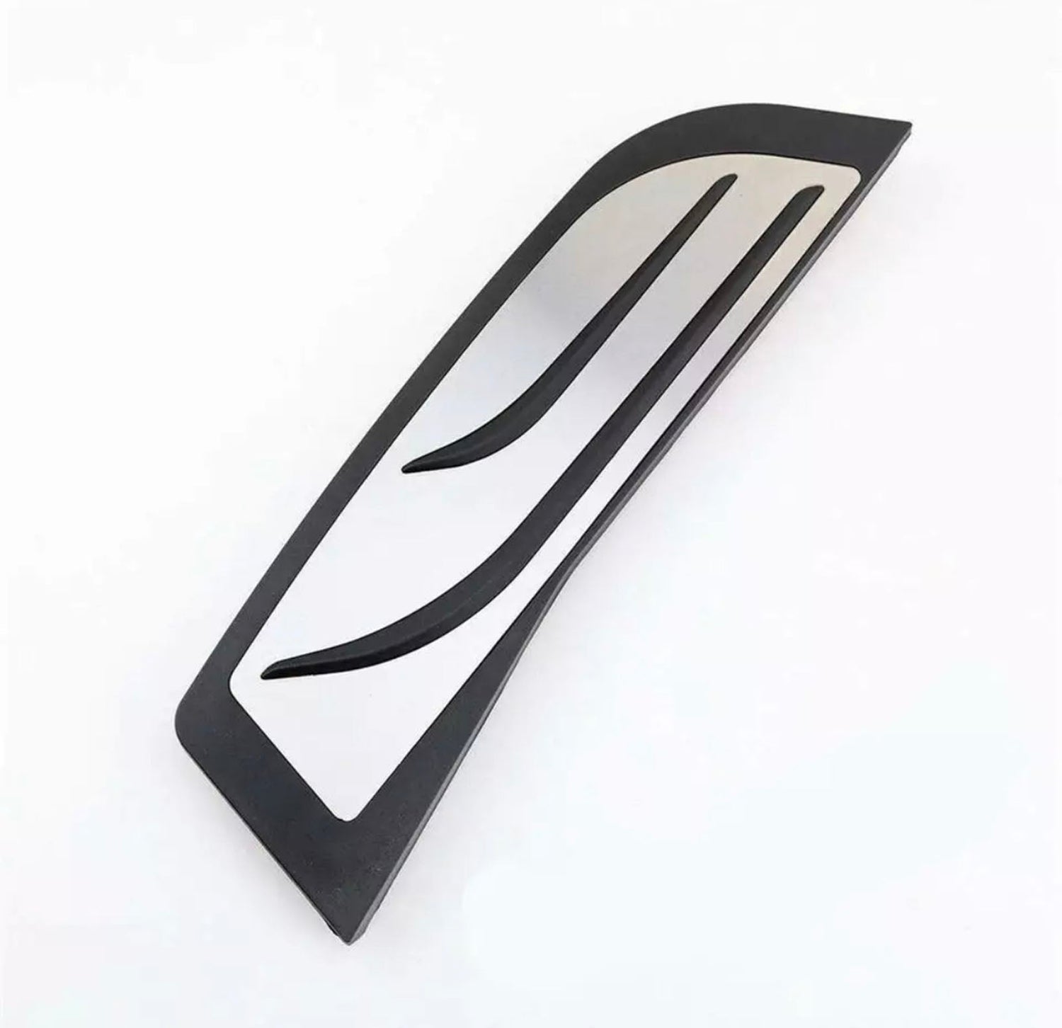 A sleek, curved black and silver abstract sculpture rests on a white background, featuring smooth lines and a modern design, suggesting minimalistic artistry.