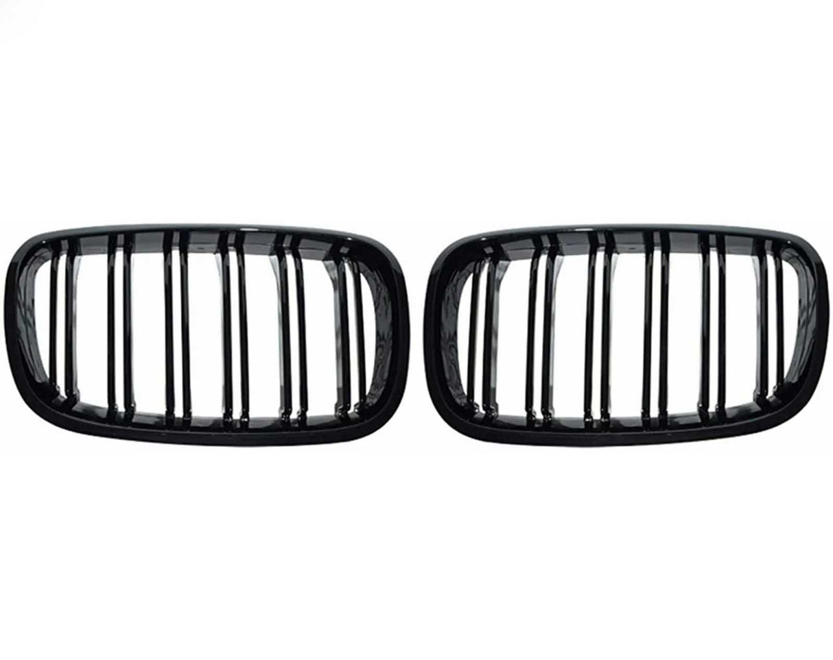 Two black, rectangular car grilles with vertical slats are symmetrically positioned on a plain white background, showcasing a sleek design.