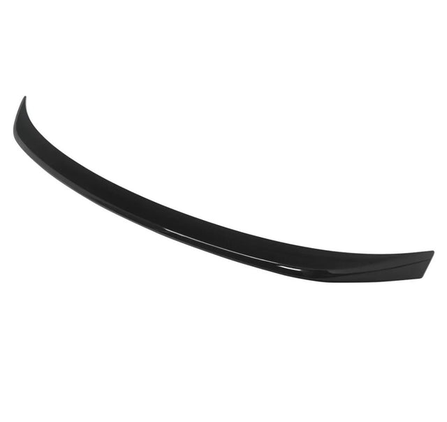 A black car spoiler curves gracefully, designed for aerodynamic effect, isolated against a plain white background.