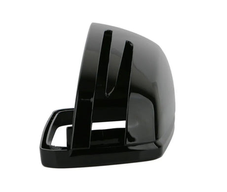 A black, glossy, rectangular object with open slots, possibly a stand or holder. The object appears stationary against a plain white background.