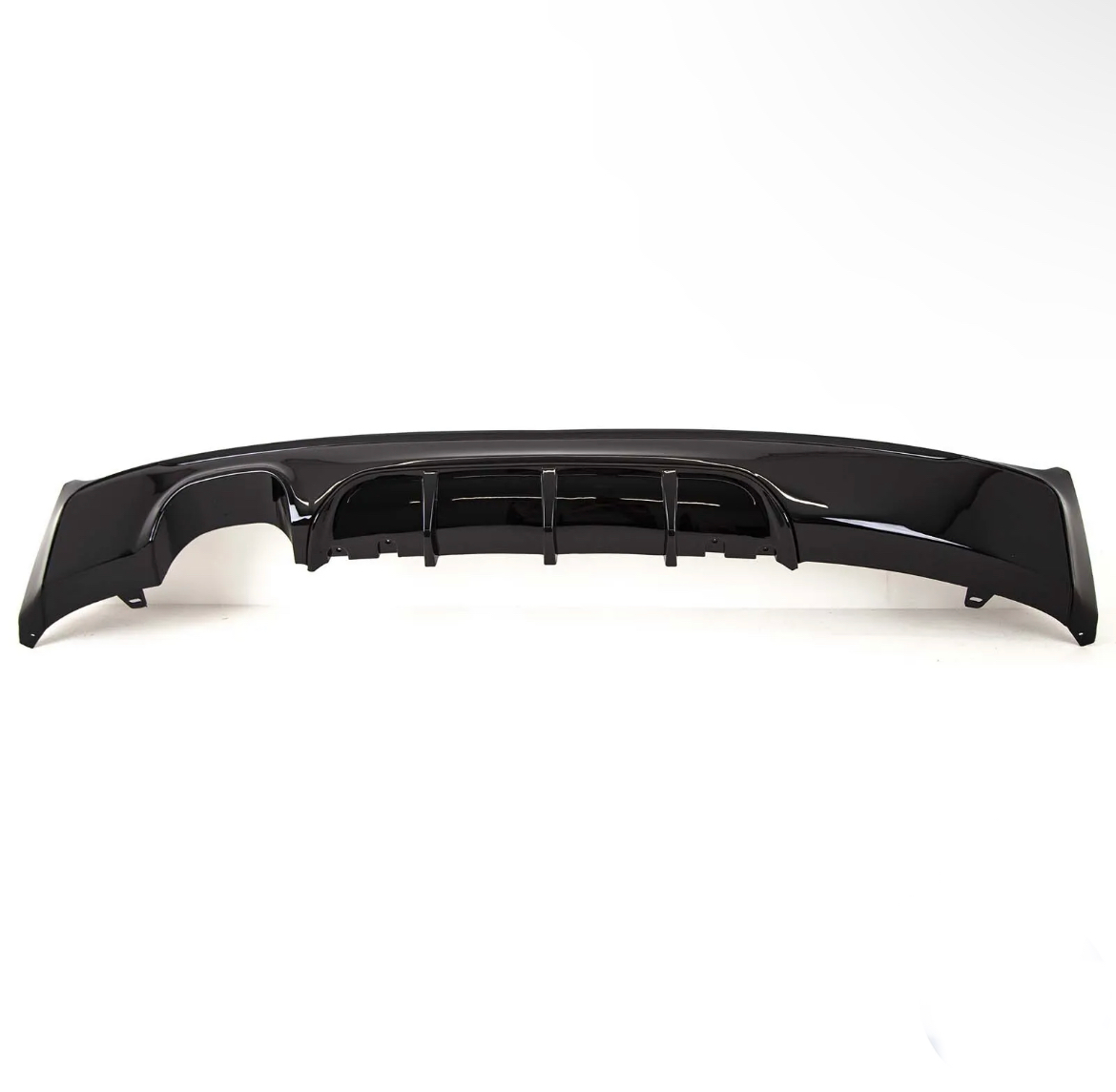 A glossy black car bumper with aerodynamic fins is resting on a plain white background, showcasing its sleek design and contours.