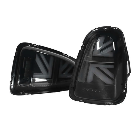 Two black automotive taillights with a stylized Union Jack pattern are positioned against a plain white background, emphasizing their design and details.
