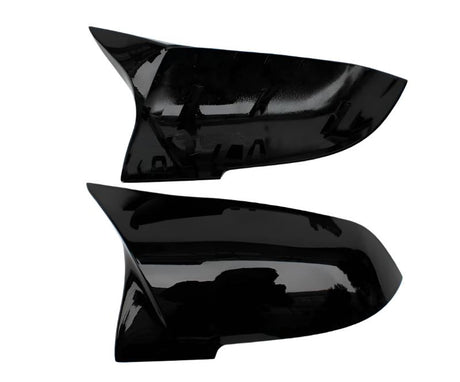 Two black, glossy car side mirror covers are displayed against a white background. The covers have a sleek, aerodynamic shape and appear unused, with no visible text or markings.