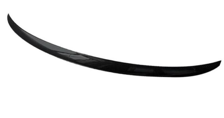 A sleek, black carbon fiber spoiler curves gracefully in a minimalist, white background.