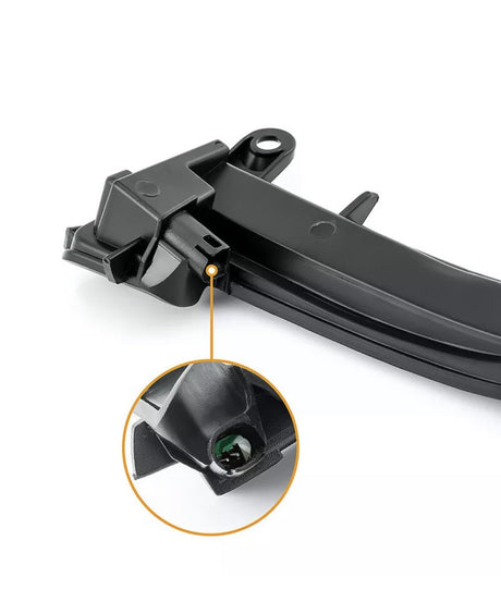 A black plastic car part, possibly a wiper blade attachment, is shown with a close-up detailing an internal bolt connection. The background is plain white.