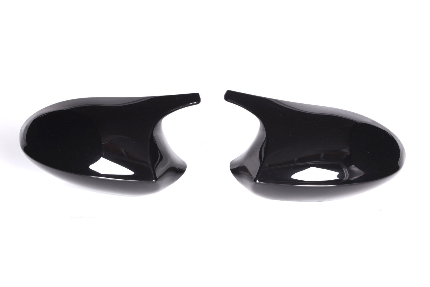 Two glossy black mirror covers face each other on a plain white background, showcasing their curved, sleek design ideal for vehicle customization.