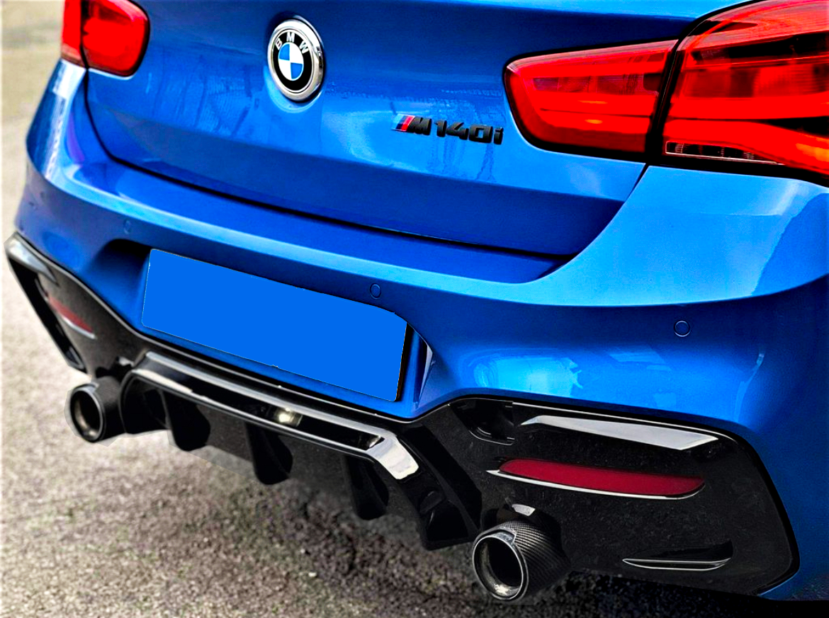 The image shows the rear of a blue BMW car with dual exhausts, parked on asphalt. The badge reads "BMW" with "M140i" displayed near the rear light.