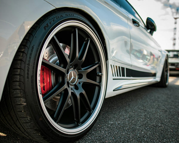 Photo by Aliaksei Semirski: https://www.pexels.com/photo/white-mercedes-benz-wheel-close-up-photo-13972881/