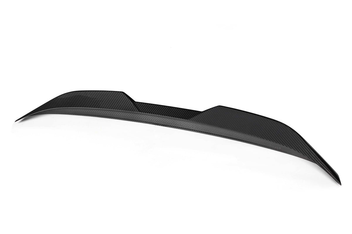 Black carbon fiber car spoiler with a textured surface, arched design, and pointed edges, positioned against a plain white background.