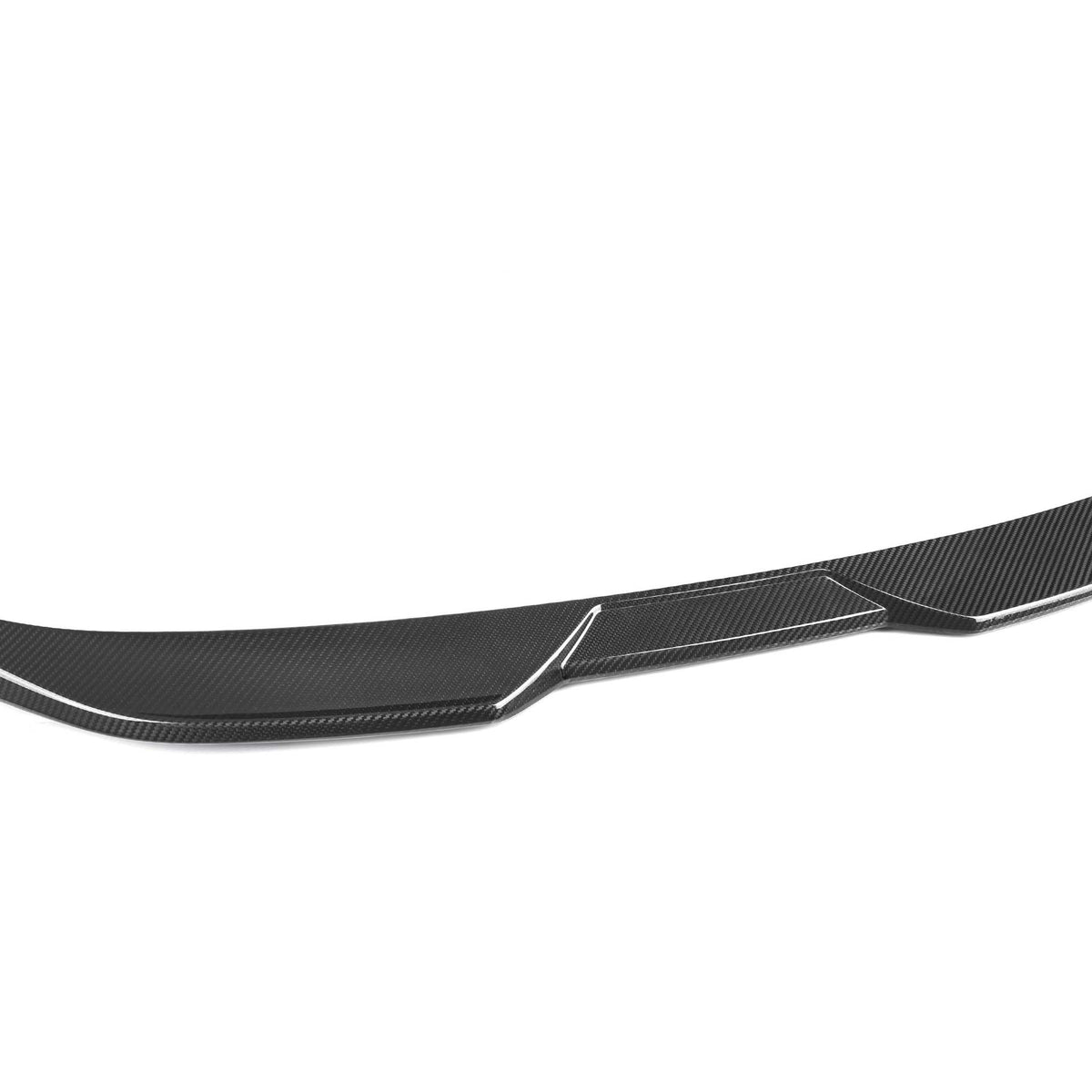 A sleek carbon fiber car spoiler with a subtle curve lies on a white background, highlighting its textured surface and aerodynamic design.