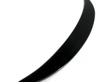 A sleek, curved black object, resembling a thin crescent, lies on a white surface. The object is glossy and tapers to a point at both ends.