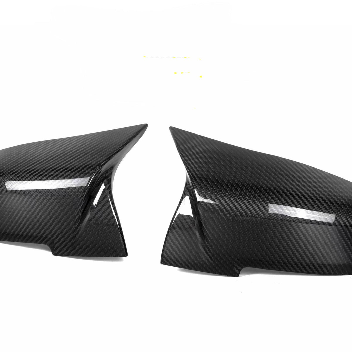 Two carbon fiber car mirror covers are positioned symmetrically against a white background, displaying a sleek, glossy finish with a visible weave pattern.